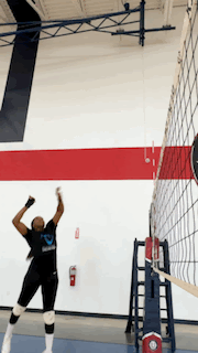 Player jumping to attack at the net